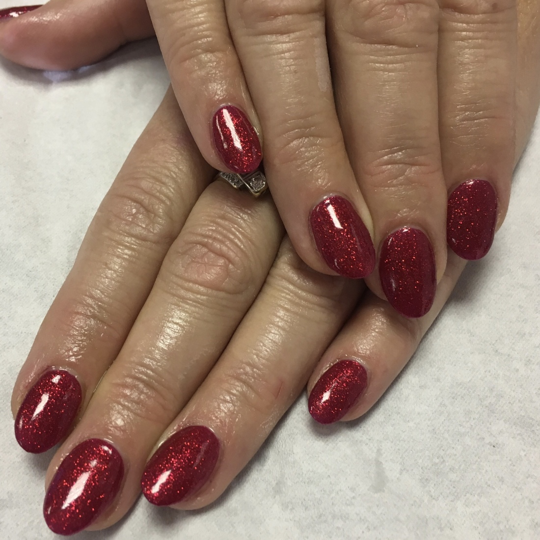 Red glitter nails with a rounded finish