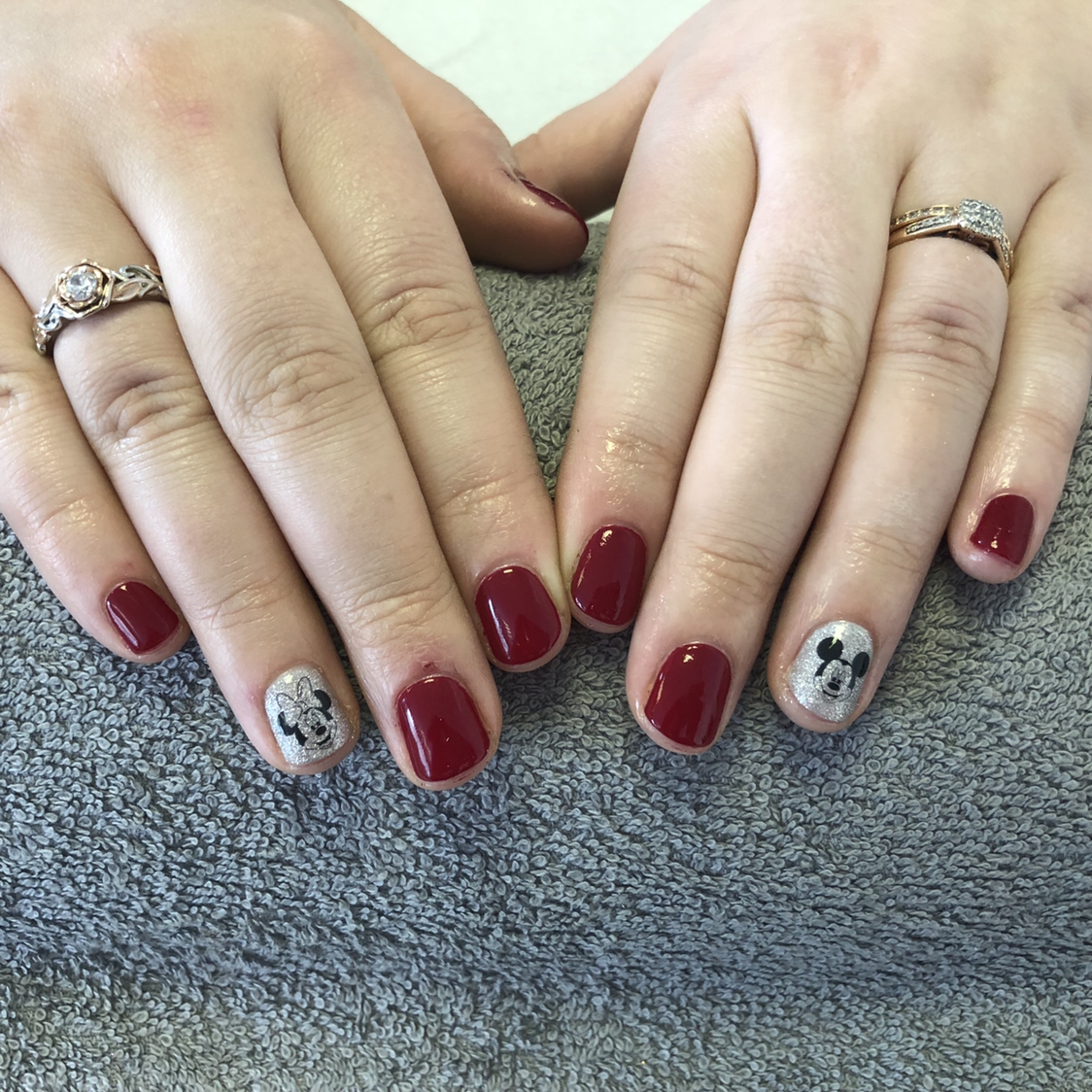 Burgundy and silver nails with illustrated accent details